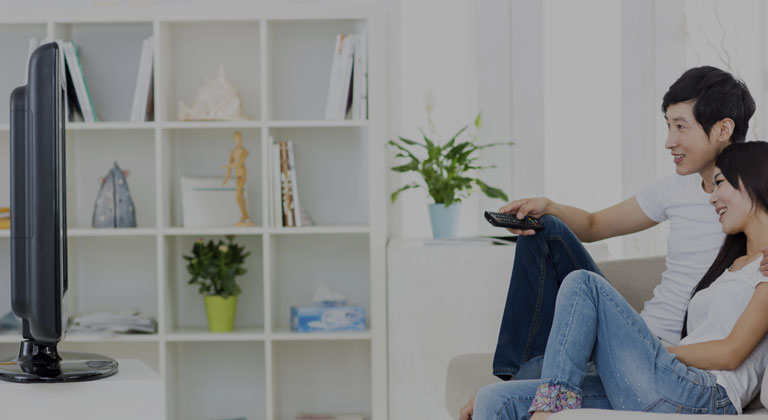 A couple watching television from their couch